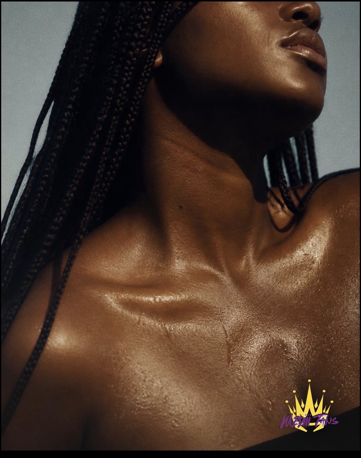 Water beading across a bronzed shoulder and neck